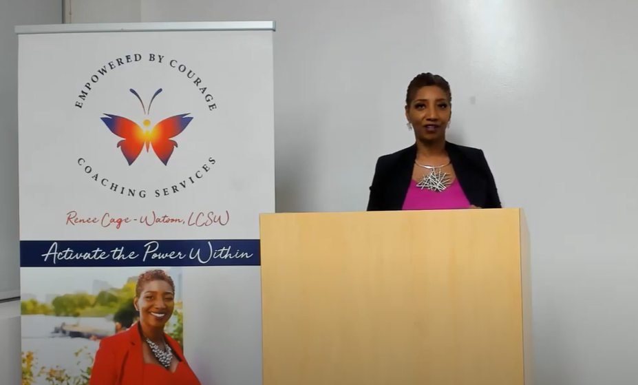 A woman standing at the front of a podium.